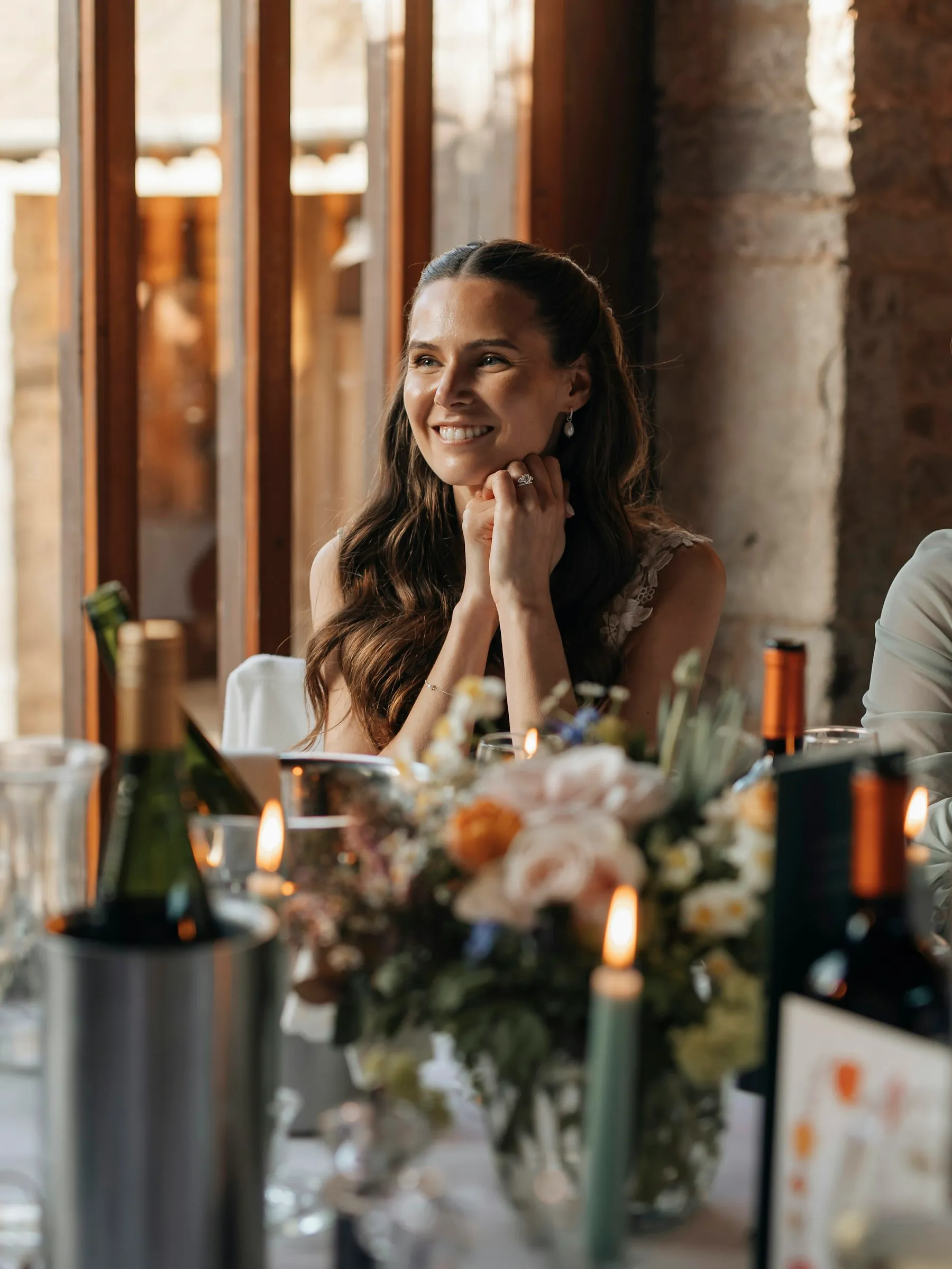 A guest smiling across the dinner table