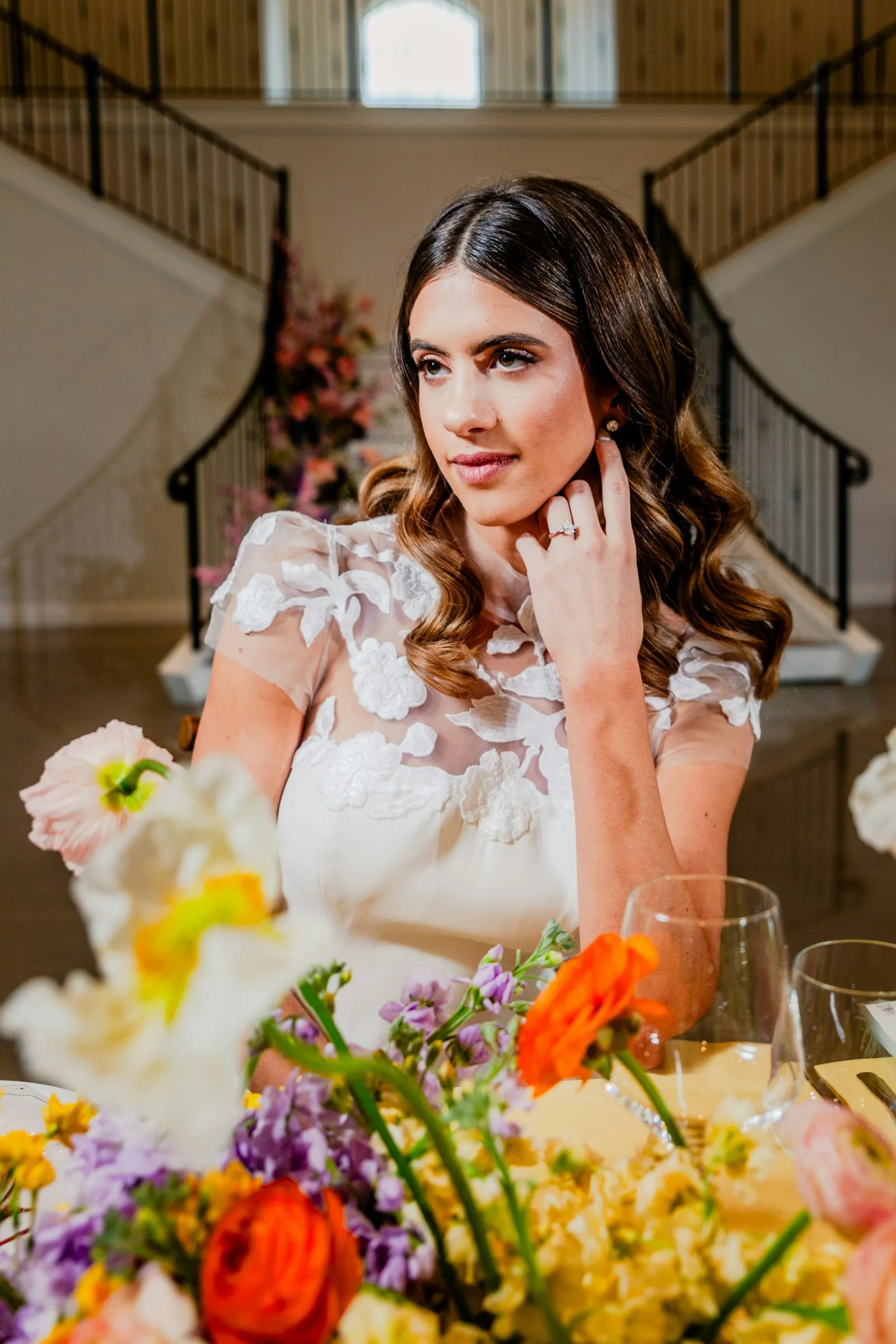Clara among the flowers, hand at her earring