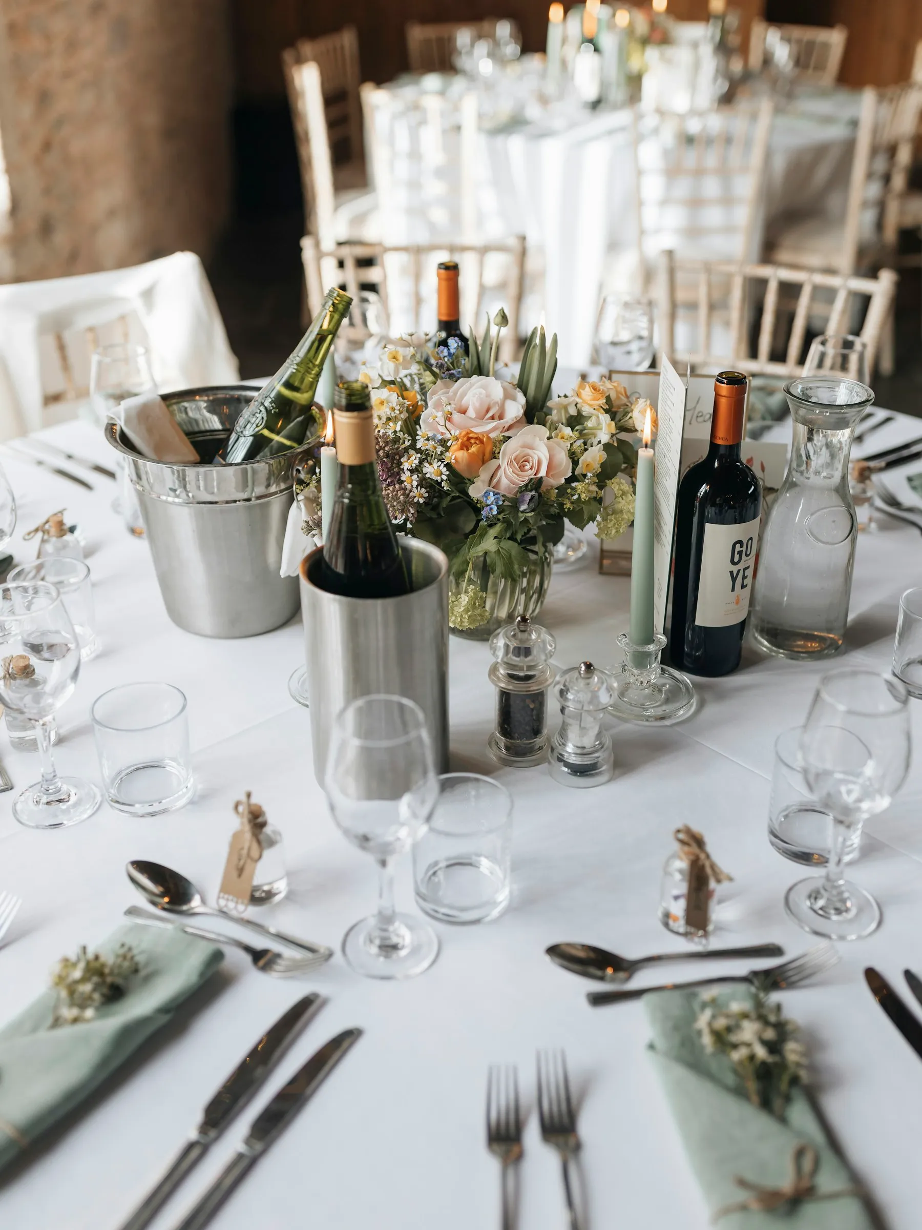 A reception table set with flowers and candles