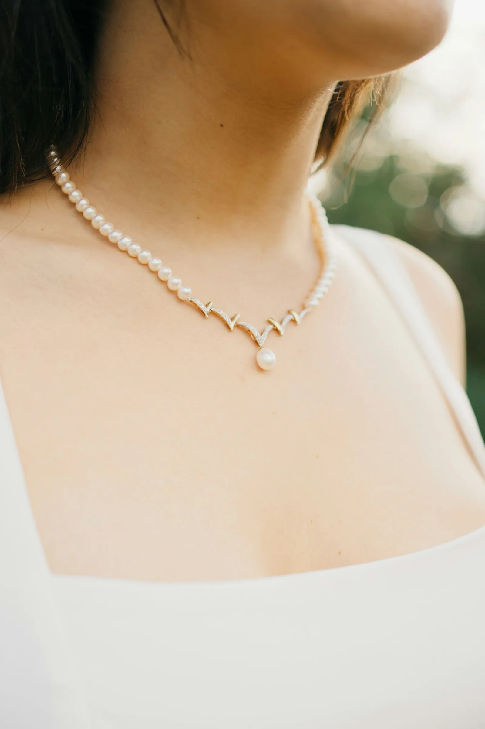 A pearl necklace against Sophie’s collarbone