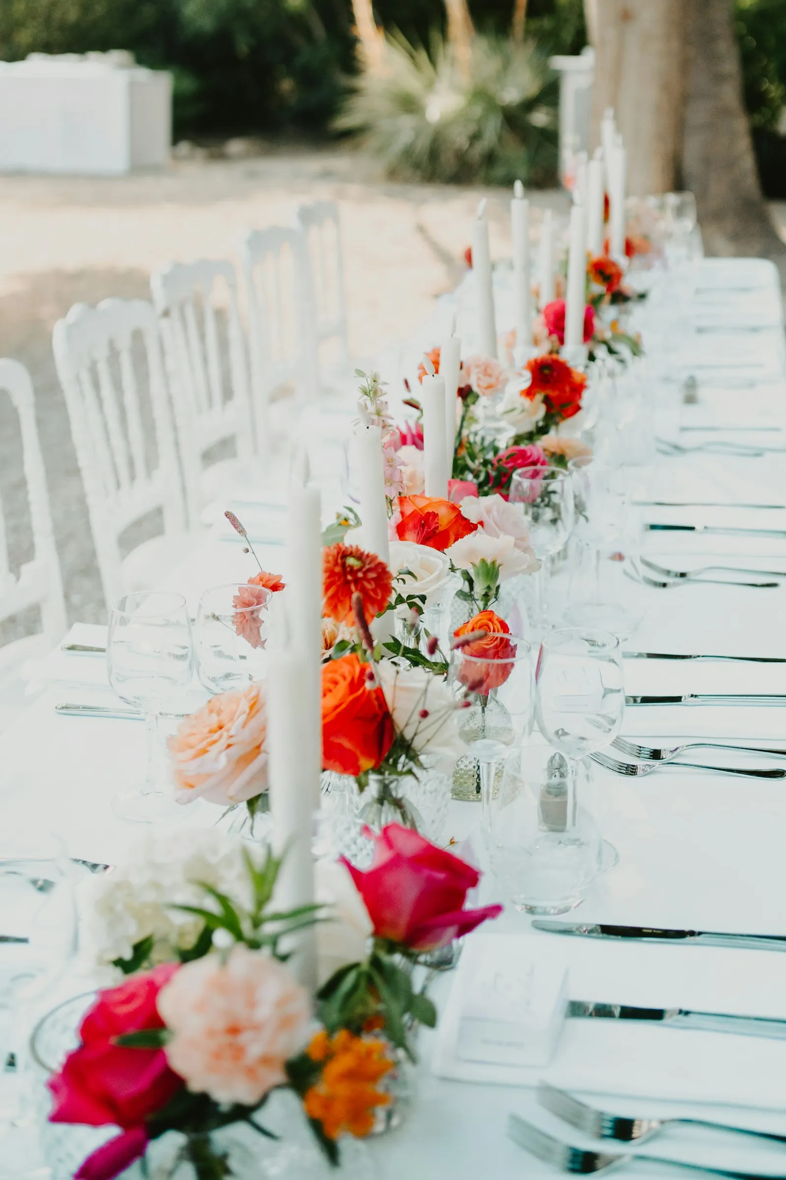 A long table with flowers and candles
