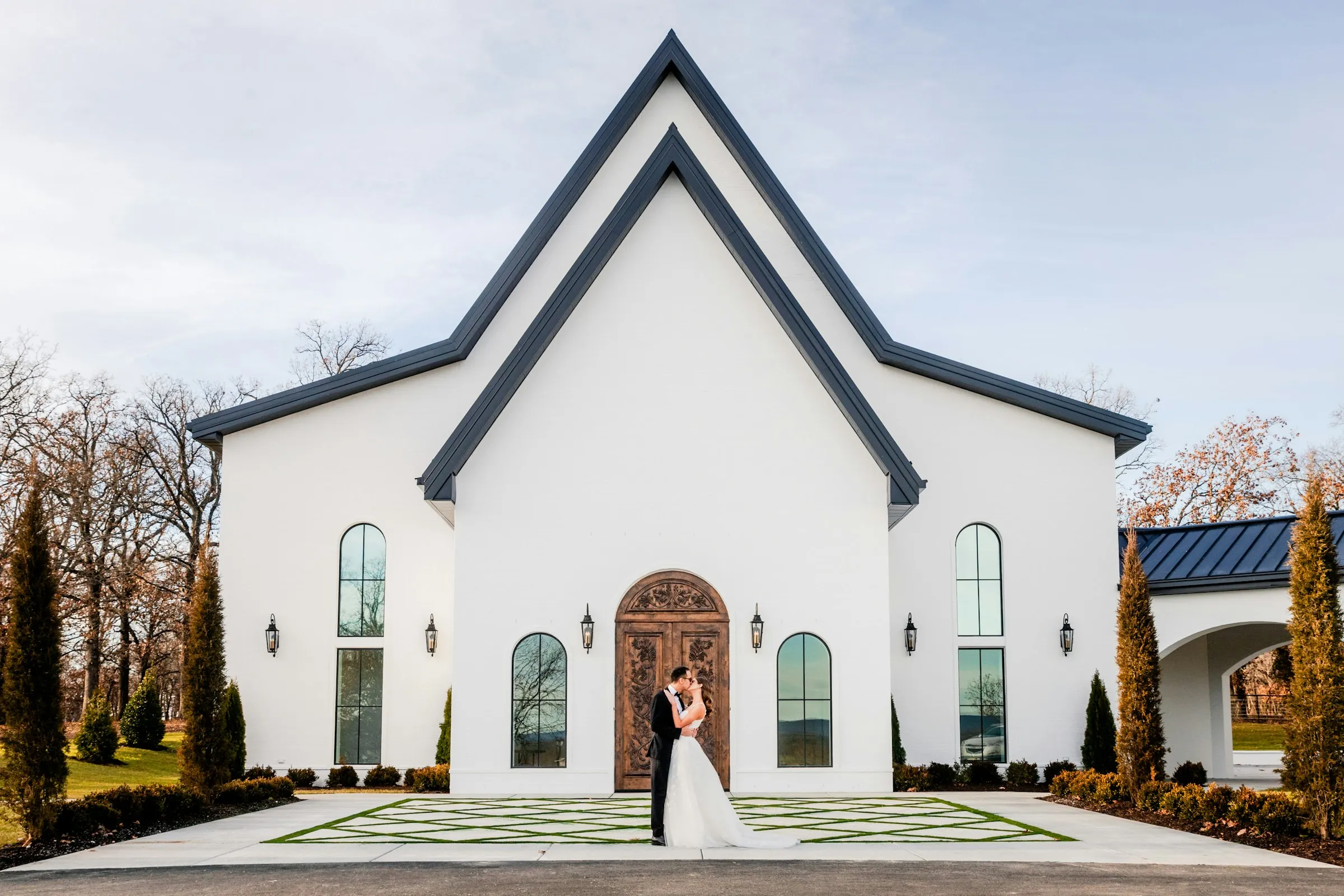 The white chapel with the couple at its doors