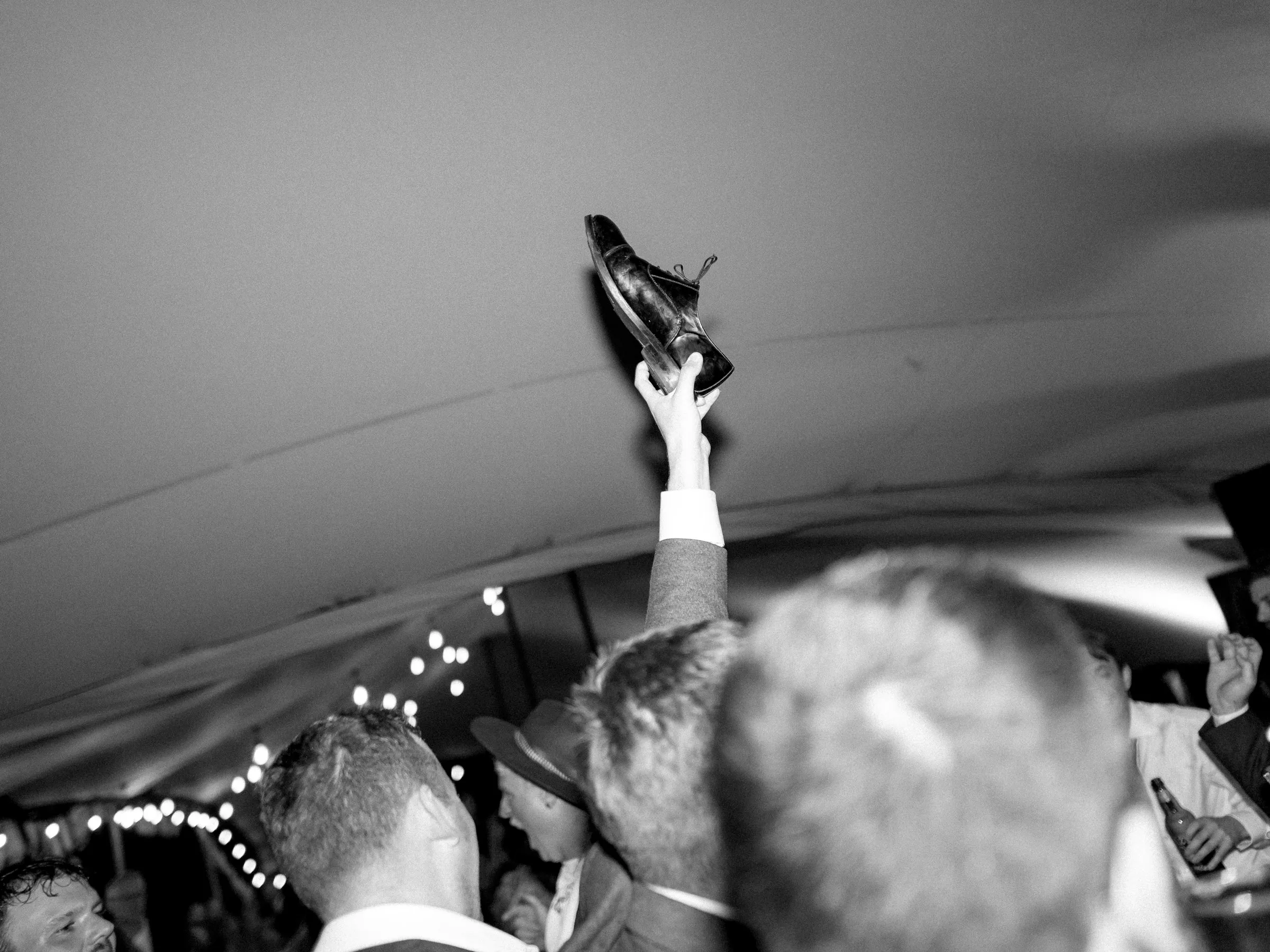 A shoe held high above the dance floor