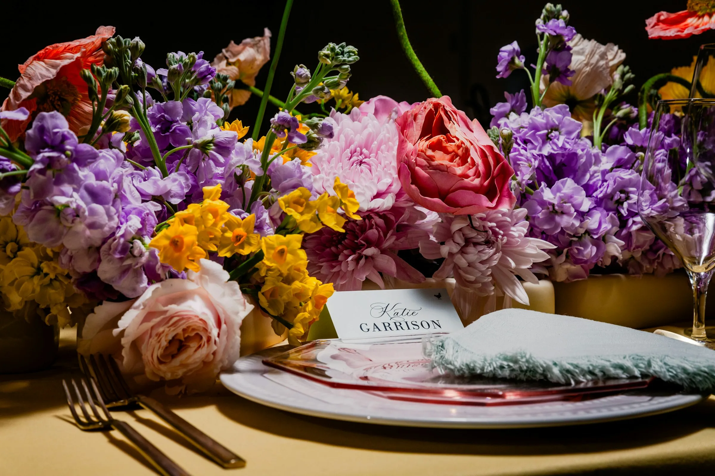 A table of violet, pink and yellow flowers