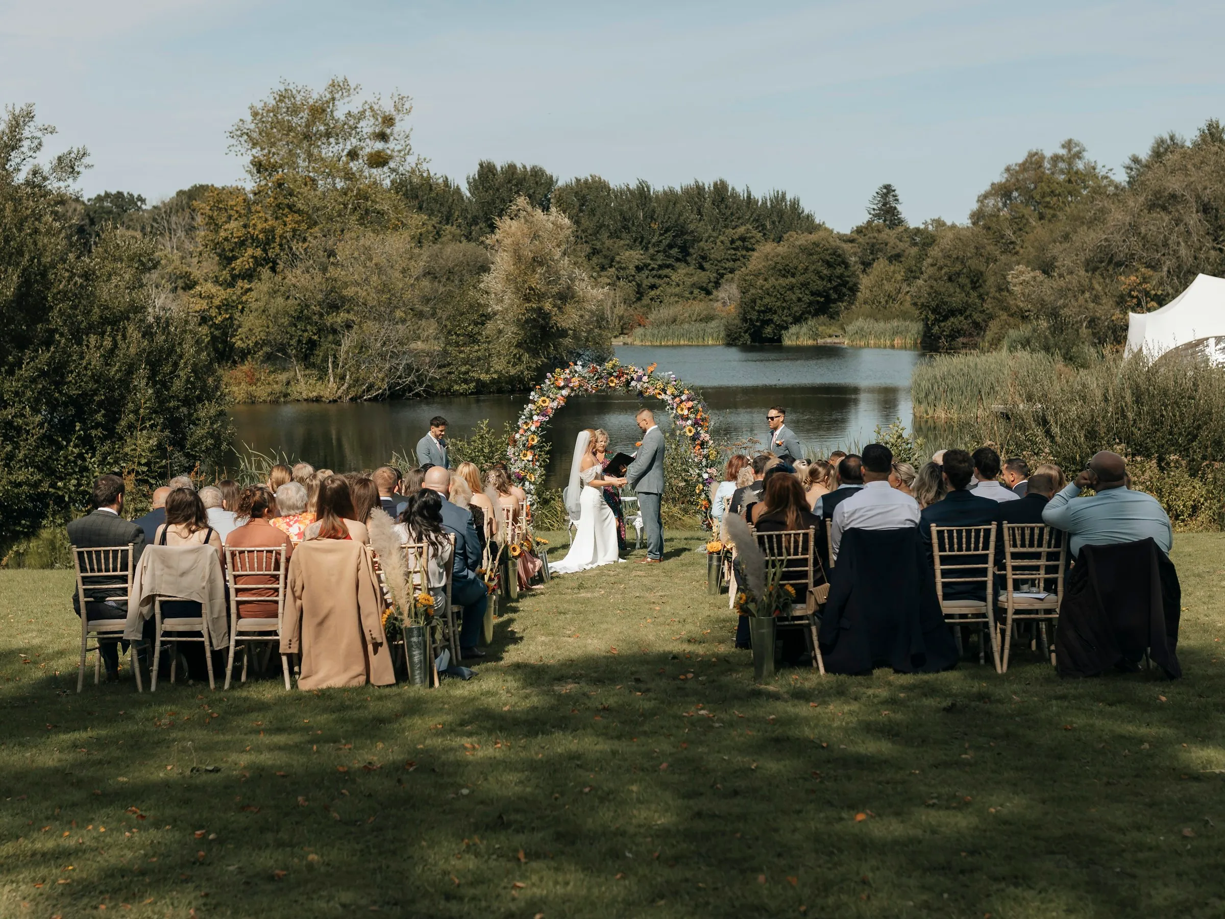 Guests seated for the ceremony beside the lake