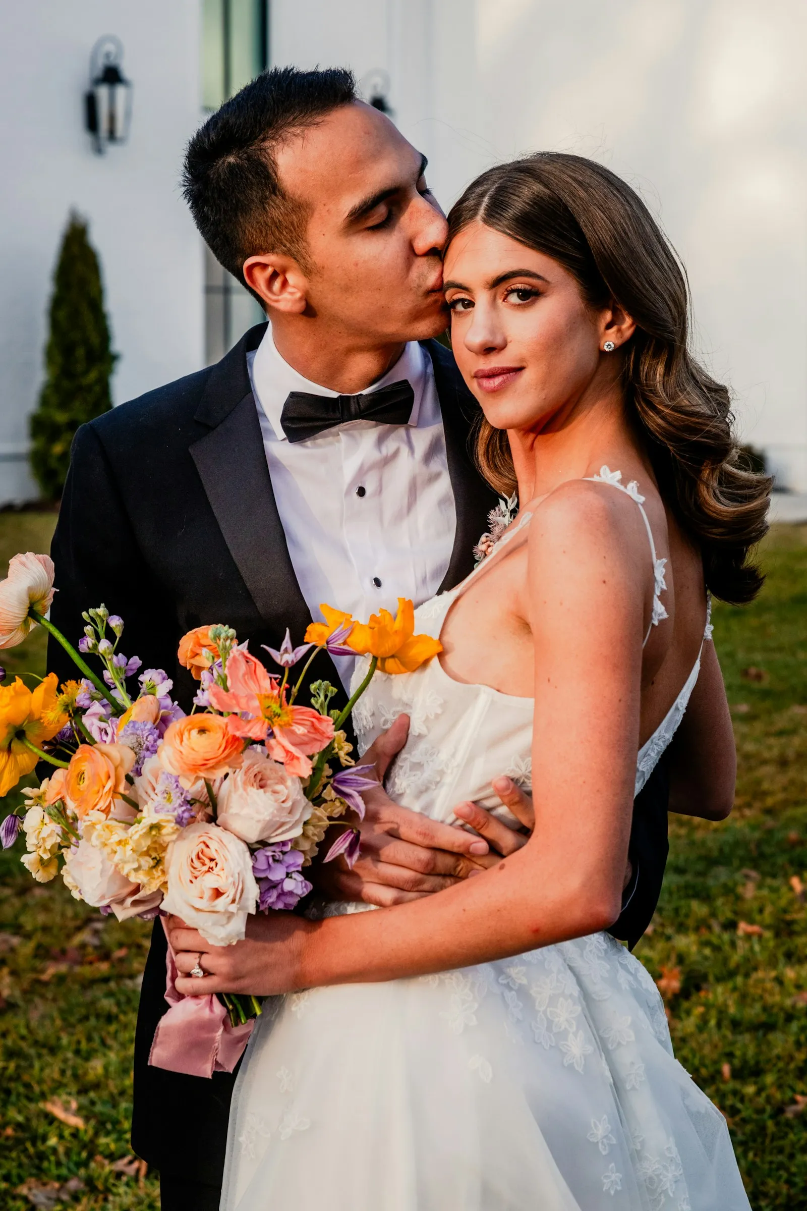 Duarte kissing Clara’s temple, bouquet between them